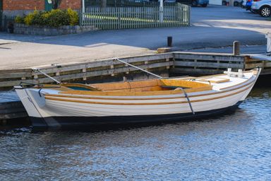 rowboat docked by a street